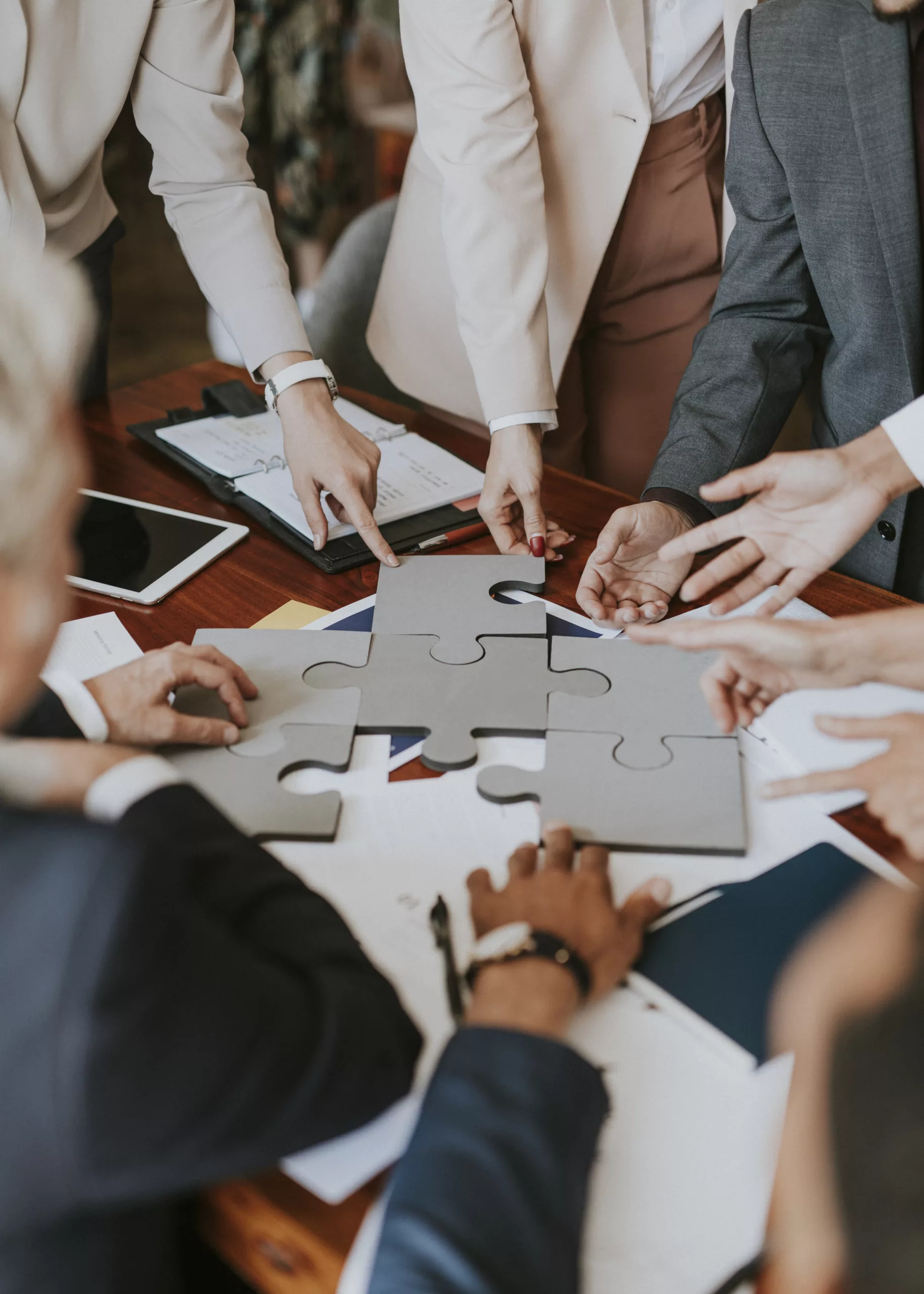 business people connecting puzzle pieces together